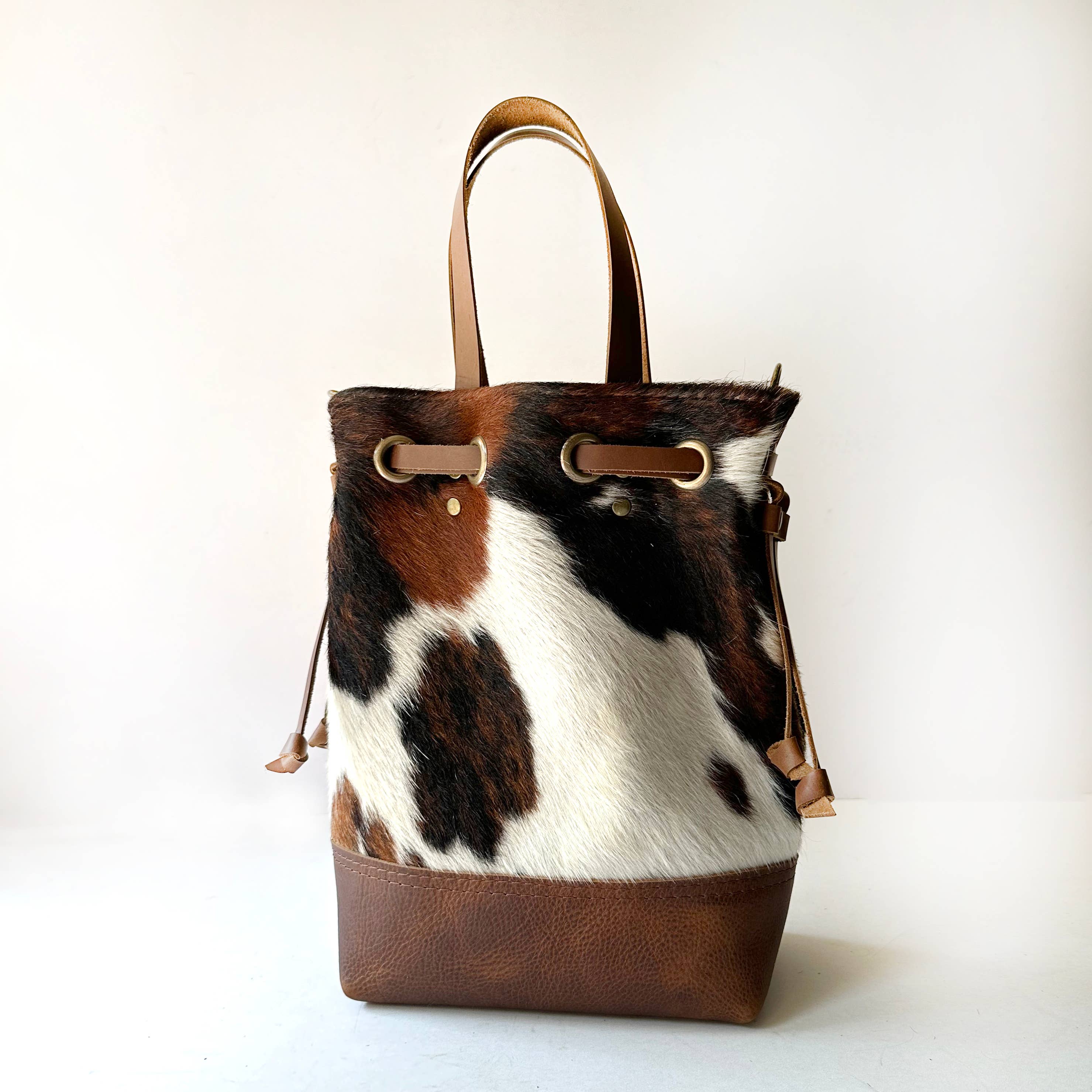 Cowhide Convertible Drawstring Backpack: Tricolor / Brown
